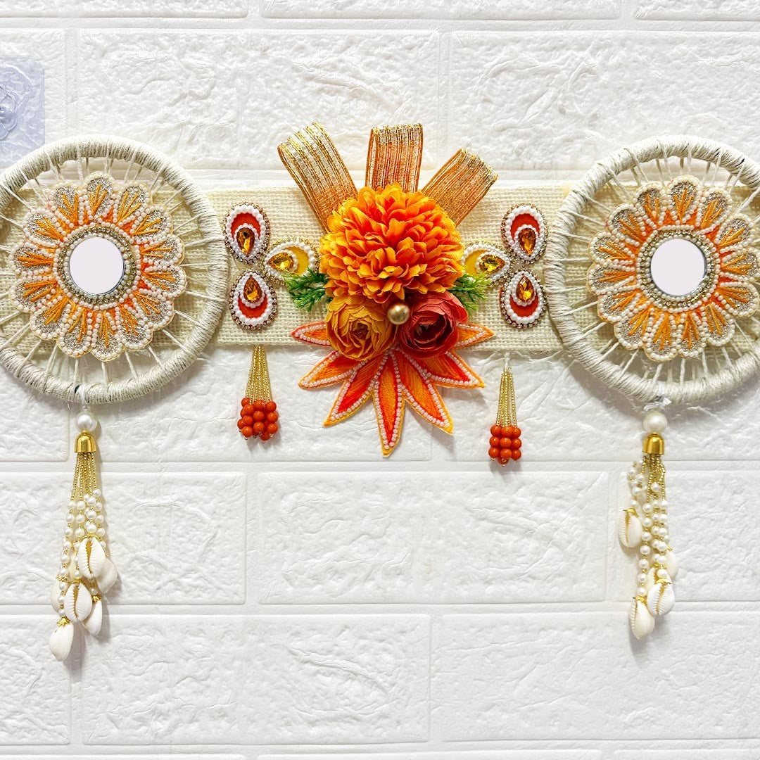 Adikala orange floral toran door hanging with shell tassels and mirror details. 40 inch festive bandanwar for home entrance and mandir.