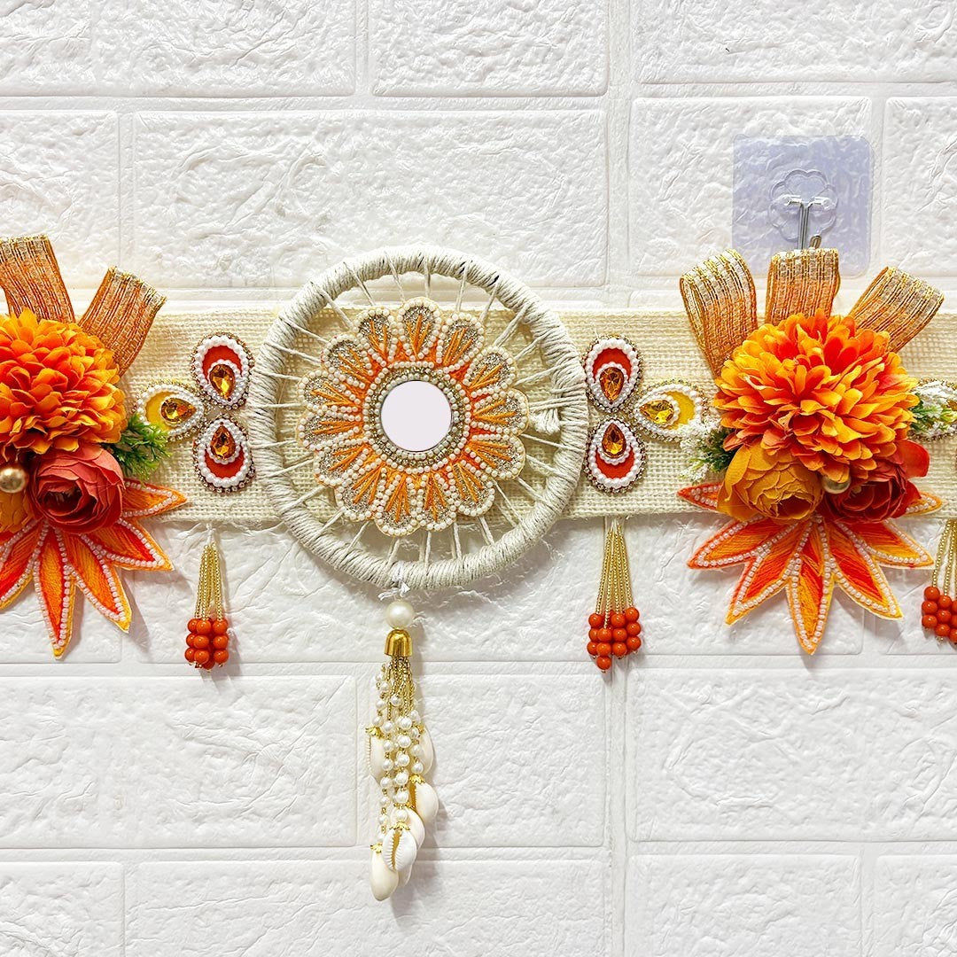 Adikala orange floral toran door hanging with mirror, beads, shells, and fabric flowers. 40-inch length.